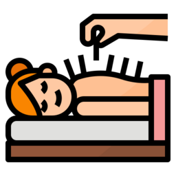 Person lying face-up on a treatment table while a hand inserts a needle near their forehead