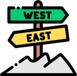 Signpost with WEST and EAST arrows atop a mountain silhouette